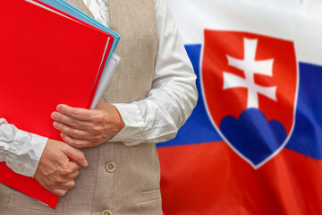 Woman holding red folder on Slovakia flag background. Education and jurisprudence concept in Slovakia