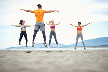 Young people having fitness on the beach