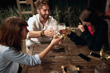 A man and his female friends making toast in the bar