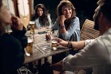 A man flirting with the girl in the bar on the lake