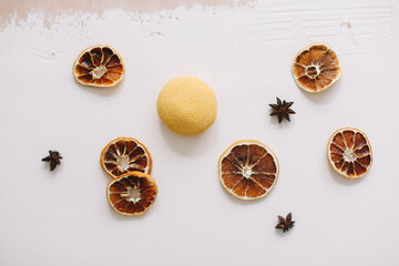 Natural soap with dried slices of oranges on a white background. Handmade soap and ingredients. Flat lay. Space for text, top view