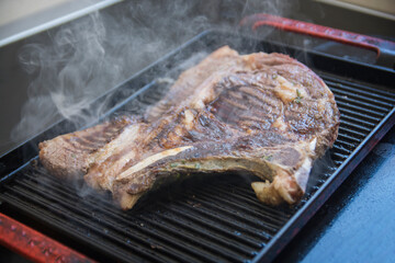Close up view of a Sirloin cut steak, being grilled on a grilling pan