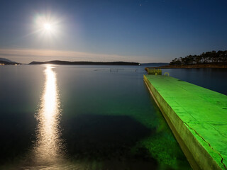 Full moon over tha bay of Banjol on island Rab in Croatia