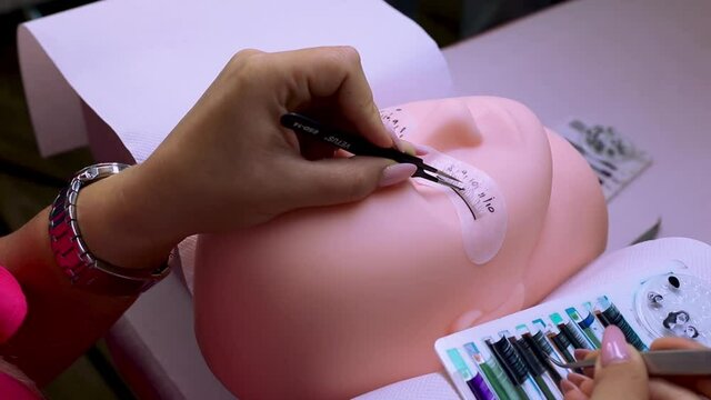 Eyelash extensions process on a mannequin model footage