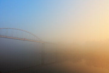 Fototapeta na wymiar foot bridge in the fog in the fall. Gomel, Belarus