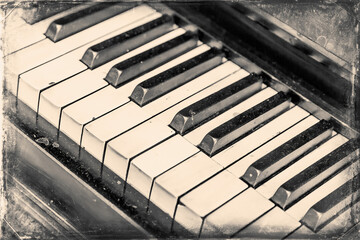 Part of an old antique grand piano with faded keys