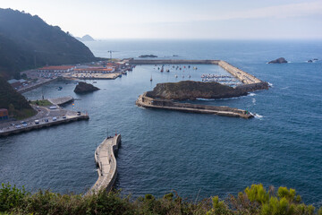 Small fishing harbor in the North of Spain, by the Atlantic ocean. Hidden natural harbor surrounded by hills. Tourism and fishing industry are the main sources of economy in Cudillero, Asturias, Spain