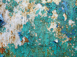 Surface of rusty iron with remnants of old multicolored paint texture background. Rust, corrosion...