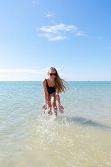 Woman enjoying her holidays at the tropical beach. Happy young woman enjoys her beach vacation