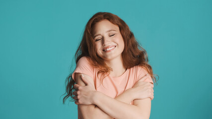 Pretty charming girl cutely posing on camera over colorful background. Happy expression