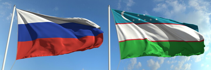 Flags of Russia and Uzbekistan on flagpoles. 3d rendering