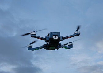 Drone flying against cloudy sky, bottom view