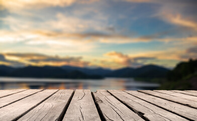 Naklejka na ściany i meble Showcase an old wooden table shelf on a beautiful sunset and blurred nature background. 