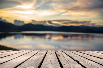 Naklejka na ściany i meble Showcase an old wooden table shelf on a beautiful sunset and blurred nature background. 