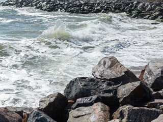 Panoramic seascape. Huge stormy waves crashing into huge stones near the city’s Black Sea embankment.