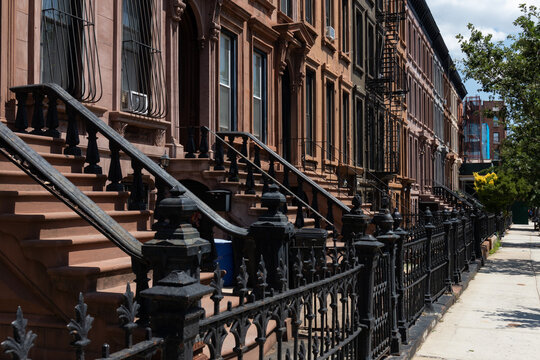 Row of Old Brownstone Homes in Bedford-Stuyvesant in Brooklyn of New York City along an Empty Sidewalk