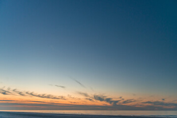 Beautiful sunset with some clouds on the beach of Ameland in the Netherlands, beautiful color nature photo