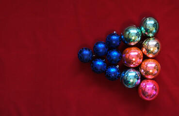 balls, multicolored Christmas toys on a red background