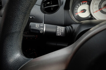 Fototapeta na wymiar Windscreen wiper control switch in car. Wipers control. Modern car interior detail. adjusting speed of screen wipers in car