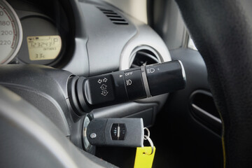 Switch off lights in a car. close-up Car integrated turning indicator with headlight switch toggle.