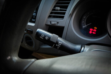 Windscreen wiper control switch in car. Wipers control. Modern car interior detail. adjusting speed of screen wipers in car