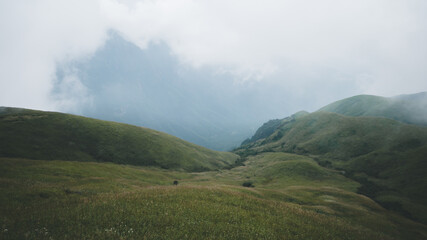 Meadow landscape with mountains covered by clouds on Wugong Mountain in Jiangxi, China