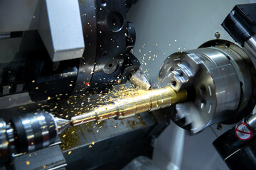 Metal machine tools industry. CNC turning machine high-speed cutting is operation.flying sparks of...