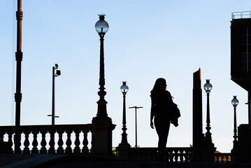 Woman is walking in front National Museum. City background with lamps