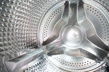 Inside of laundry washing machine. Rotating inner tub. Material stainless steel. Shot taken in the...
