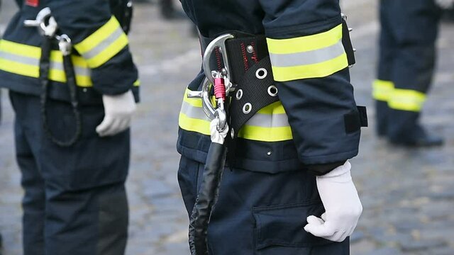 Fire fighters uniform detail with carabiner and harness during ceremony 