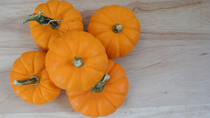 Pile of miniature pumpkins on a wooden board