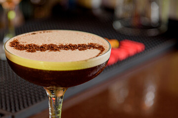 young woman bartender makes cocktail with medical mask and protection against coronavirus COVID-19.
