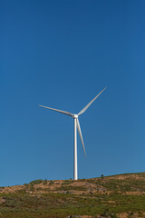 View of a wind turbine on top of mountains, ecological and environmental theme