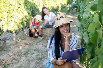 Beautiful woman in vineyard. We've had a good yield this season