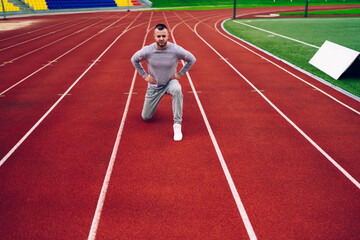 Portrait of determined caucasian hipster guy squatting for training legs muscles reading slimming and losing weight, serious handsome sportsman having warming exercises before jogging in morning