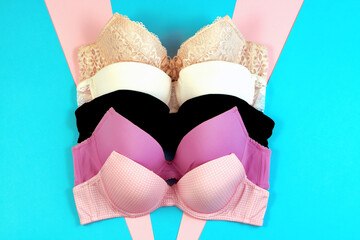 Set of women's bra on blue background. Underwear fashion concept. Basic lingerie flatly top view