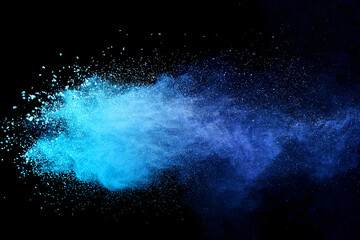 Blue sky color powder explosion on black background.