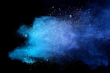 Blue sky color powder explosion on black background.