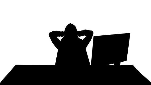 Silhouette Stressed tired out of work hacker looking at pc monitor.