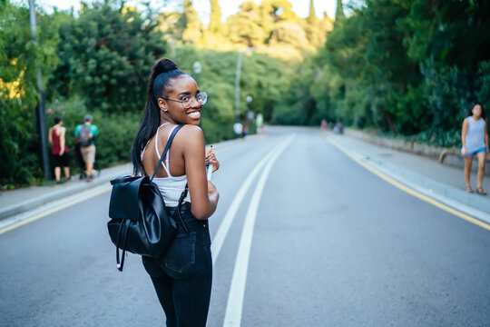 Positive Black Woman With Tablet Looking Over Shoulder