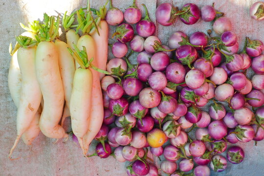 Fresh Parsnips And Small Round Eggplants Sold In An Asian Food Street Market