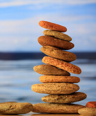 Fototapeta na wymiar Zen stones stack on blue sky and sea background