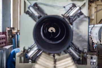 Modern plastic pipes production line. Close-up of form.