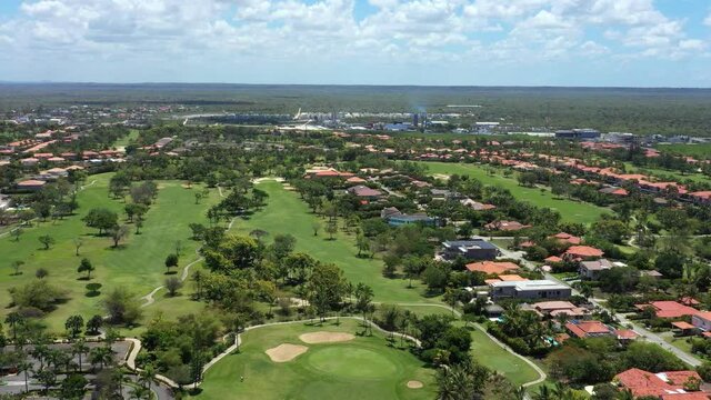 Aerial view on golf course with road and palm trees and houses