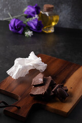 Fototapeta na wymiar Chocolate and Almonds on a black-toned wood floor