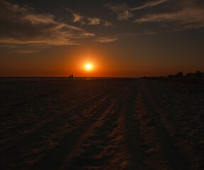 Beautiful sunset in sky, sandy beach on the sea coast