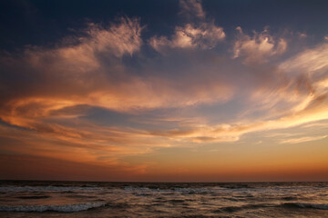 Fototapeta na wymiar Beautiful sunset in sky, sandy beach on sea coast
