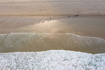 The cold water of the Atlantic Ocean washes onto the sandy beaches of Cape Cod, Massachusetts. This scenic peninsula is a popular summer vacation destination in New England.