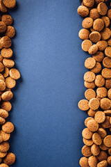 Dutch holiday Sinterklaas background with kruidnoten, pepernoten, traditional sweets, strooigoed. Flat lay with copy space. Saint Nicholas day concept for children party