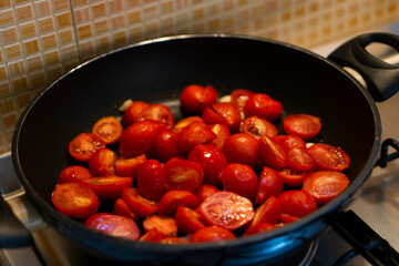 Chef cooking food for italian cuisine, tomato sauce for pasta, mediterranean diet concpet, detailed view of hands and pan with fried tomatoes